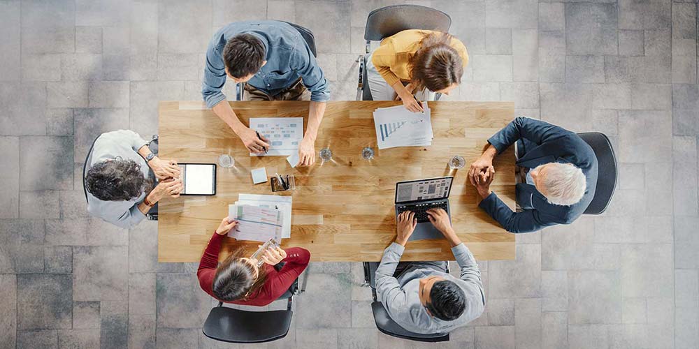 top view of a financial team coordinating planning at office desk